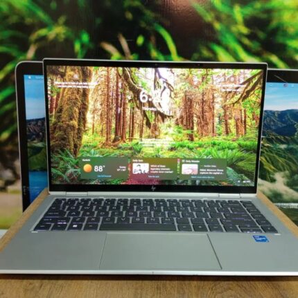 Ultra-thin silver HP EliteBook Folio 1040 G8 touchscreen laptop open on a high-end corporate desk.